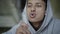 Close-up face of mixed-race boy with brown eyes blowing out match and looking at camera. Portrait of thoughtful