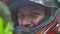 Close up face motorcyclist man in moto helmet looking to camera and smiling. Portrait moto biker man in protective