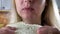 Close up face portrait of woman eating sandwich.