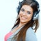 Close up face portrait of woman with headphones listening music