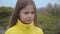 Close-up face of a pretty Caucasian girl with brown eyes listening to her mother or sister and shaking head. Cute child