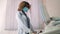 Close-up of face of professional african american obstetrician gynecologist in protective mask performing ultrasound of