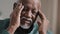 Close-up face sad elderly african american man feeling headache chronic migraine unhealthy multiracial grandpa massaging