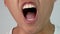 Close-up face of a sleepy and yawned young man on white background.