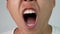 Close-up face of a sleepy and yawned young man on white background.