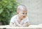 Close up face of smiling baby lying on soft bed at home terrace