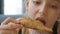 Close up face teenager girl eating italian pizza in fast food restaurant