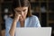 Close up face tired unmotivated female, staring at laptop screen