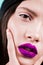 Close up face of a woman with professional make up, purple lips, detail. Fashion. Beauty portrait