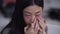 Close-up face of young slim Asian woman applying eye patches in slow motion. Headshot of beautiful charming gorgeous