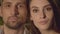 Close-up faces of adult Caucasian man and woman looking at camera. Portrait of mid-adult handsome boyfriend and young