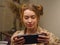 Close-up. A fair-haired girl gamer plays a video game on a portable game console. Gaming, video games, mobile games, virtual