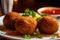 Close-up of falafel balls freshly fried and drizzled with a sweet and spicy harissa sauce on a white plate