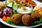 Close-up of falafel plate with assorted pickled vegetables, crispy falafel balls, and drizzled with tahini sauce
