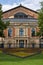 Close up from the famous bayreuth wagner festival theatre from the front with colorful flowers.