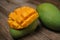 Close up of famous sweet mango called Harum Manis isolated on top of wooden background