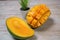 Close up of famous sweet mango called Harum Manis isolated on top of wooden background