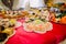 Close-up of fancy served dessert buffet on red tablecloth in luxurious party restaurant setting