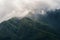 Close up of Fansipan mountain hills valley with forest and fog cloud at sunset. Panoramic view at Sapa, Vietnam. Natural landscape