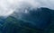 Close up of Fansipan mountain hills valley with forest and fog cloud at sunset. Panoramic view at Sapa, Vietnam. Natural landscape