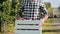 Close up of farmer carrying a full crate of apples