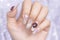 Close up Fashionista woman acrylic fingernail painting beautiful white color gel nail art decorated with cute 3D rose flower