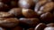 Close-up of Fast Rotating Roasted Coffee Beans, Blurry Background