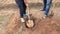 Close-up of a father and son deftly digging a hole for planting a tree.