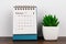 Close up of February 2023 desk calendar with potted plant