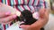 Close up of feeding newborn cute blind black kitten with a bottle of kitten milk replacer powder baby cat formula.