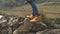 Close up of feet climber male hiker traveler man with camera walking