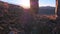 Close up of feet climber male hiker traveler man walking and climbing up in rocky top mountain at sunset