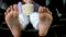 close-up of the feet in frame Girl sitting in a folding chair watching a movie eating popcorn unrecognizable people