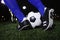 Close up of feet kicking the soccer ball, night time in the stadium