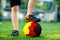 Close-up of feet of kid boy with football and soccer shoes in German national colors - black, gold and red. World or