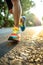 Close-up of feet in sneakers running. Low point of view. Colorful sparkling tones