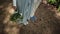 Close-up of feet of a young beautiful couple newlyweds standing in park