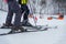 Close-up of feets of skiers in boots and skis. Ski slope, blurred focus. Winter kind of leisure, sporty lifestyle