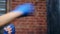 Close-up female blue wrapped hand hitting punching bag enjoying kickboxing training at loft gym