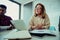 Close up female businesswoman smiling approving of ideas presented by colleague sitting around table with team during