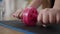 Close-up of female Caucasian hands rolling dumbbell on exercise mat. Unrecognizable plus-size overweight woman training