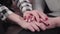 Close-up of female Caucasian mature hands holding young teen hands. Unity of grandmother and granddaughter. Family