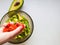 Close up of female chef hand putting Feta cheese cubes on greek vegan tomato salad with olives and lettuce leaves. The concept of