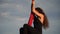 Close up of Female circus artist with red aerial silk on the sky background is slow motion. Concept of healthy lifestyle