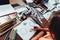 Close-up of female designer drawing floral compositions with crayons sitting at workplace surrounded with paint, gouache