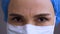 Close up of female doctor face with medical mask looking seriously and nodding with regrets. Surgeon woman head denies