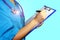 Close-up of a female doctor filling out a medical uniform. writes Doctoral documents. Handle in hand