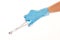 Close up of female doctor\'s hand in blue sterilized surgical glove with forceps against white