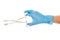 Close up of female doctor\'s hand in blue sterilized surgical glove with forceps against white