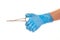 Close up of female doctor\'s hand in blue sterilized surgical glove with forceps against white